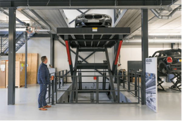 man-standing-in-front-of-car-elevator