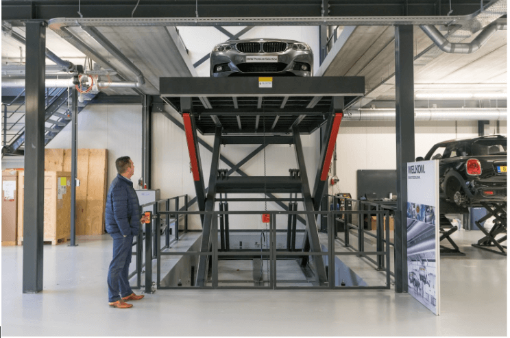 man-standing-in-front-of-car-elevator